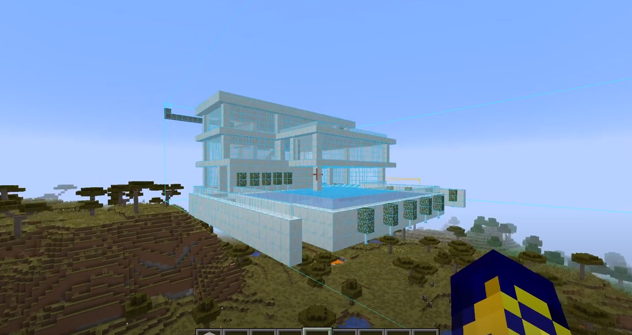 A screenshot showing the schematica mod in action, with a hologram version of a modern house in the air
